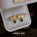 Gold Tone Textured Bow And Black Rectangular Stone Drop Earrings view 4