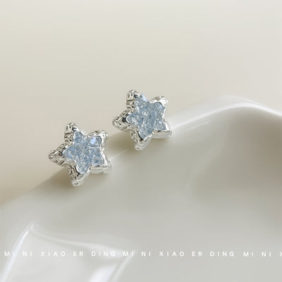 Silver-tone pale-blue glass-crystal star studs in the first product display.