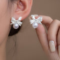 Silver Tone Bow and White Pearl Look Small Stud Earrings view 1