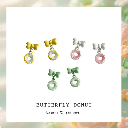Pink green and yellow bow donut drop earrings on white card
