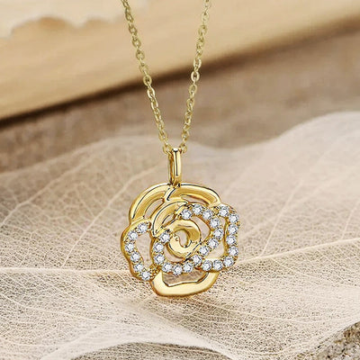 Product view showing a layered open rose pendant accented with a curved row of clear stones