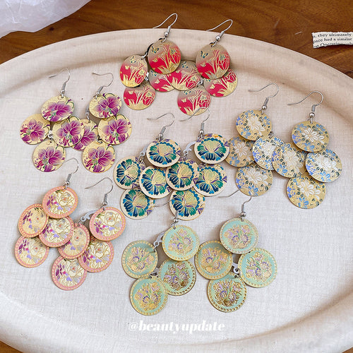 Three linked round discs printed with colorful vintage-style flowers displayed in a close product arrangement.