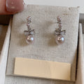 Pair of Metal Tone Pink Pearl Bow Stud Earrings with Clear Crystals view 3