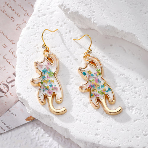 Stretching upright cat silhouette resin earrings with multicolor flowers