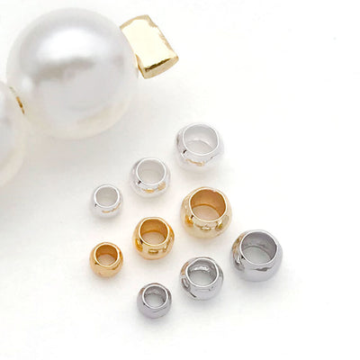Smooth metal open crimp covers in three sizes arranged as a full product overview