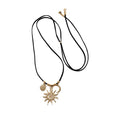 Gold Tone Sun and Moon Pendant Necklace on Black Cord view 5