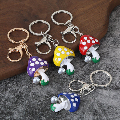 Group of polka-dot mushroom keychains in bright colors