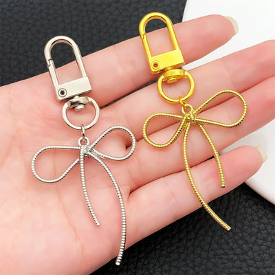 Overview showing the available color and design variations of the gold and silver rope bow metal clasp keychain design