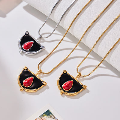 Neckline view of black red enamel fan pendant necklaces in main image 1.