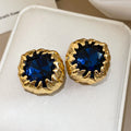 Deep Blue Faceted Stone Stud Earrings in Textured Gold Tone view 6