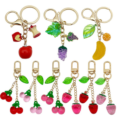 Front display of nine strawberry cherry orange apple and grape keychains with visible colors and attached hardware