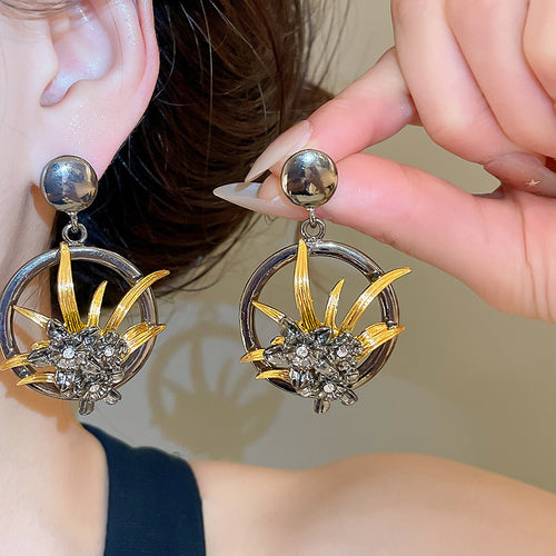 Black and Gold Openwork Floral Statement Stud Earrings shown in a styled close-up