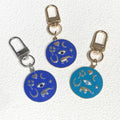 Gold Tone Round Enamel Eye and Celestial Clip Keychains view 2