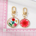 Gold Tone Pressed Flower Resin Clip Keychains in Eight Round and Irregular Designs view 5