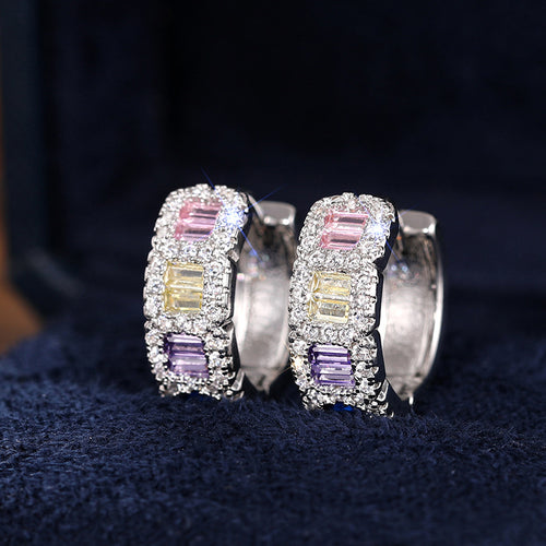 Angled detail of silver tone multicolor baguette crystal huggie earrings