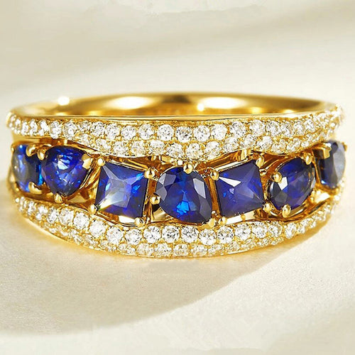 Front close-up of gold blue mixed-cut stone pave band ring