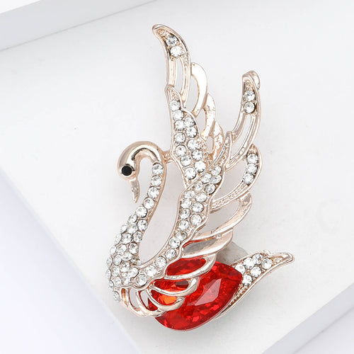 Angled display of the crystal swan brooch on a white surface