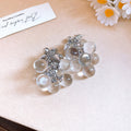 White Floral Shell and Pearl Drop Earring Collection view 10