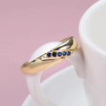 Gold Crossover Band Ring Blue Round Stone Line Accents view 3