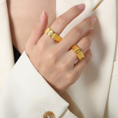 Gold buckle open cuff rings worn on index and ring fingers