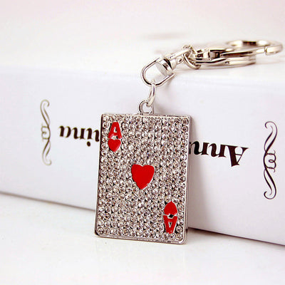 Close-up front view of the rhinestone playing card charm with red heart details.