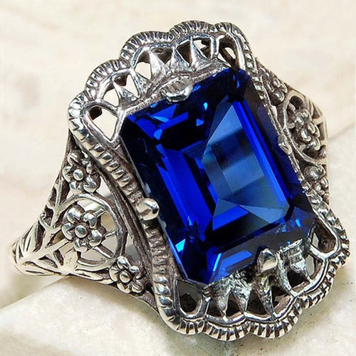 Front view of royal blue rectangular crystal filigree ring in silver tone