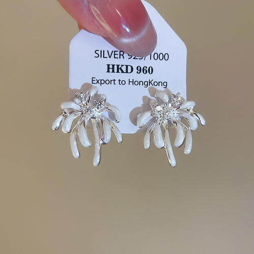Styled wear view of 银色幻彩花朵耳钉 showing layered pale petals with an iridescent finish and small clear-stone centers