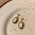 Gold Tone Pearl Top Black White Cameo Profile Medallion Drop Earrings view 3