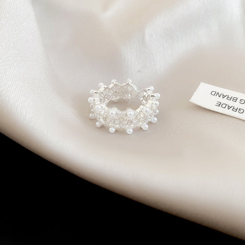 Wide silver pearl lace open ring on satin fabric
