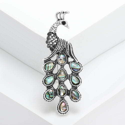 Front view silver peacock brooch with abalone shell tail feathers