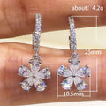 Silver Flower Drop Hoop Earrings In A Polished Decorative Design view 4