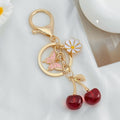 Cherry Charm Keychain with Enamel Butterfly and Daisy Flower Pendant view 3