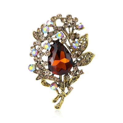 Front view of a large teardrop jewel surrounded by crystal flowers and leaves