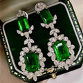 White Gold Tone Green Emerald Cut Crystal Drop Earrings view 1