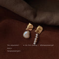 Gold Tone Pleated Top And Asymmetric White Pearl Drop Earrings view 1