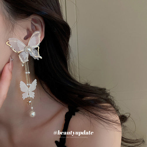 Styled close-up of white butterfly jewelry