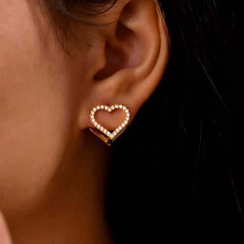 Gold clear pave open heart stud earring on ear close-up