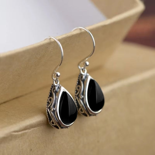 Second product view showing opalescent teardrop earrings