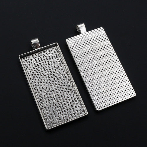 Grouped detail view of long rectangular pendant trays with dotted textured backs