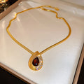 Gold Tone Red Teardrop Necklace and Stud Earrings with Polished Metal Accents view 6