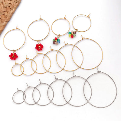 Gold-tone cross jewelry findings arranged on a light background