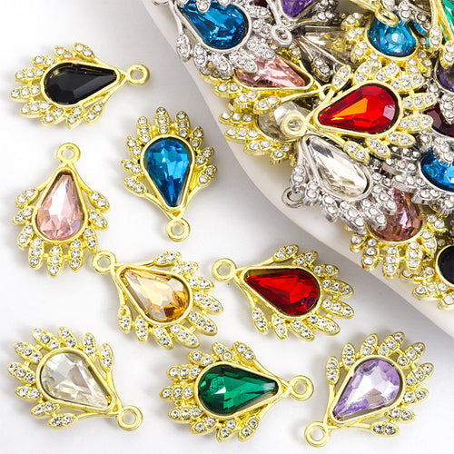 Assorted teardrop charms arranged on a white surface