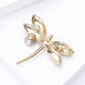 Pink Enamel Dragonfly Brooch With Polished Metal And Sculpted Decorative Details view 4