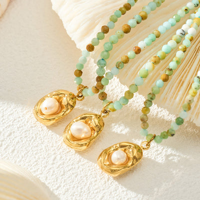 Close green stone beads with three gold irregular pearl pendants on shells