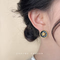 Black Enamel Gold Camellia Round Clip Stud Earrings view 2