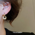 Pair of Metal Tone Gold Tone Sculpted Oval Drop Hoop Earrings view 3