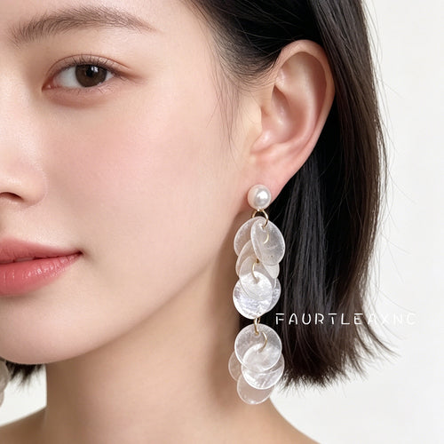 Gold-tone white-pearl translucent-shell-disc long studs shown worn on an ear.