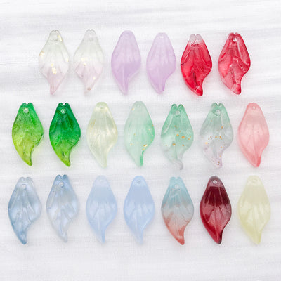 Colorful leaf and bead beads arranged on a light background
