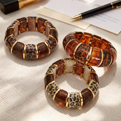 On-wrist view of leopard pattern resin bracelets in main image 1.