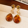 Amber Brown Oval Drop Stud Earrings With Decorative Metal Details view 1